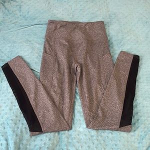 Grey high rise leggings with pockets and black mesh on lower leg.